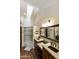 Bathroom featuring double sinks with granite countertops and a walk-in shower with glass door at 9280 E Davenport Dr, Scottsdale, AZ 85260