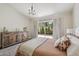 Bright main bedroom with hardwood floors, patio access and custom furniture at 9280 E Davenport Dr, Scottsdale, AZ 85260