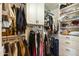 Organized walk-in closet with built-in shelving, drawers, and ample hanging space for clothes and accessories at 9280 E Davenport Dr, Scottsdale, AZ 85260