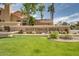 Well-maintained Scottsdale Hills community entrance with lush green grass, mature trees and cacti at 9280 E Davenport Dr, Scottsdale, AZ 85260
