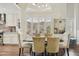 Dining area boasts a modern chandelier and cozy seating, with views into the kitchen at 9280 E Davenport Dr, Scottsdale, AZ 85260
