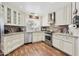 Bright kitchen featuring white cabinets, stainless steel appliances, and granite countertops at 9280 E Davenport Dr, Scottsdale, AZ 85260