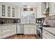 Bright kitchen with white cabinets, stainless steel appliances, and granite countertops at 9280 E Davenport Dr, Scottsdale, AZ 85260