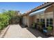 Paver patio with a blue and white striped awning, sliding glass door and view of the yard at 9280 E Davenport Dr, Scottsdale, AZ 85260