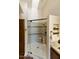 Walk-in shower with glass door featuring a shower head, bench, and shelving niche at 9280 E Davenport Dr, Scottsdale, AZ 85260