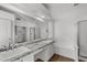This bathroom has double sinks with stone counters and large mirrors at 9631 E Palm Ridge Dr, Scottsdale, AZ 85260