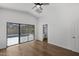 Bright bedroom boasts hardwood floors and a ceiling fan with sliding doors leading to the pool at 9631 E Palm Ridge Dr, Scottsdale, AZ 85260