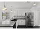 Bright kitchen with stainless steel refrigerator, granite counters, and mosaic backsplash at 9631 E Palm Ridge Dr, Scottsdale, AZ 85260