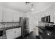 Well-equipped kitchen featuring modern appliances, granite countertops, and white cabinets at 9631 E Palm Ridge Dr, Scottsdale, AZ 85260