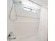 Bright and clean bathroom with a shower/tub combo and white tiled walls at , Mesa, AZ 85201