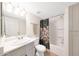 Bathroom with a shower-tub combo, floral curtain, sink and grey vanity at , Mesa, AZ 85201