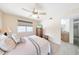 Inviting bedroom with a ceiling fan, dresser, and view to the ensuite bathroom at , Mesa, AZ 85201