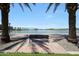 Peaceful view with park benches framed by palm trees, overlooking the tranquil lake and community features at , Mesa, AZ 85201