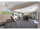 Bright community gym area with mirrored wall, equipment, and weight rack at , Mesa, AZ 85201