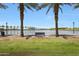 Beautiful view of the pond lined with palm trees and a bench to sit and relax at , Mesa, AZ 85201