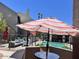 Inviting community pool area with lounge seating, umbrellas, and shade structures at , Mesa, AZ 85201