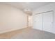 Carpeted bedroom featuring double closets and neutral walls at 101 N 7Th St # 168, Phoenix, AZ 85034