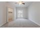 Carpeted bedroom with a closet, neutral walls, and a window overlooking the building exterior at 101 N 7Th St # 168, Phoenix, AZ 85034