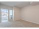 Neutral carpeted bedroom featuring a glass door to the balcony at 101 N 7Th St # 168, Phoenix, AZ 85034