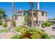 Beautiful exterior showcasing the building with a serene pond, lush greenery, and desert landscaping at 101 N 7Th St # 168, Phoenix, AZ 85034