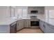 Updated kitchen with stainless steel appliances and light gray cabinets with modern black pulls at 101 N 7Th St # 168, Phoenix, AZ 85034