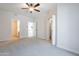 Spacious carpeted main bedroom with a closet, ceiling fan, and neutral colors at 101 N 7Th St # 168, Phoenix, AZ 85034