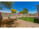 Low maintenance backyard with desert landscaping, green grass, and block wall fence at 10212 E Caballero St, Mesa, AZ 85207