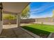 Covered patio overlooking a well-maintained backyard with lush green grass and desert landscaping at 10212 E Caballero St, Mesa, AZ 85207