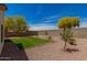 Green backyard with block wall fence and desert landscaping at 10212 E Caballero St, Mesa, AZ 85207
