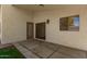 Covered backyard patio with access to green grass and desert landscaping at 10212 E Caballero St, Mesa, AZ 85207