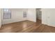 Light bedroom with wood-look floors and access to an ensuite bathroom featuring dual windows at 10212 E Caballero St, Mesa, AZ 85207
