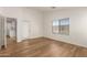 Bright bedroom with wood-look floors, a window and an exterior door provides convenient access at 10212 E Caballero St, Mesa, AZ 85207