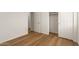 Bedroom with wood-look floors and closets, creating a clean and functional space at 10212 E Caballero St, Mesa, AZ 85207