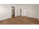 Bedroom with wood-look floors, a walk-in closet, and access to an exterior door at 10212 E Caballero St, Mesa, AZ 85207
