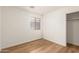 Bright bedroom with wood-look floors, natural light, and a closet for ample storage at 10212 E Caballero St, Mesa, AZ 85207