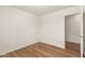 Bedroom with wood-look floors, closet, and a neutral color scheme at 10212 E Caballero St, Mesa, AZ 85207