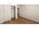 Bedroom with wood-look floors and closets, creating a clean and functional space at 10212 E Caballero St, Mesa, AZ 85207