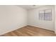 Empty bedroom featuring wood-look floors and a window bringing in natural light at 10212 E Caballero St, Mesa, AZ 85207