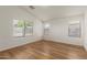 Spacious bedroom featuring wood-look flooring and multiple windows providing plenty of natural light at 10212 E Caballero St, Mesa, AZ 85207