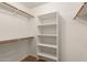 Walk-in closet with built-in shelving and hanging rods for optimal organization and storage at 10212 E Caballero St, Mesa, AZ 85207