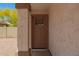 A close up view of a brown front door with craftsman style glass and a covered porch at 10212 E Caballero St, Mesa, AZ 85207