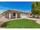 Inviting single-story home with lush green lawn, a two-car garage, and a charming covered porch at 10212 E Caballero St, Mesa, AZ 85207