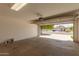 Open garage with automatic door opener offering ample space for parking and storage at 10212 E Caballero St, Mesa, AZ 85207