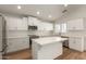 Kitchen with stainless steel appliances, white cabinets, and an island in the center at 10212 E Caballero St, Mesa, AZ 85207