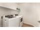 Bright laundry room with a washer and dryer, a shelf and wood-look flooring at 10212 E Caballero St, Mesa, AZ 85207