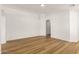 A spacious living room featuring neutral walls and new wood-look floors, perfect for modern living at 10212 E Caballero St, Mesa, AZ 85207