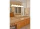 Bathroom featuring a large vanity with granite countertops and a separate tub area at 11290 N 117Th St, Scottsdale, AZ 85259