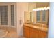 Bright bathroom with vanity, granite countertops, and a large tub under bay windows at 11290 N 117Th St, Scottsdale, AZ 85259