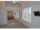 Bedroom with natural light, plantation shutters, mirrored closet, and a wall-mounted television at 11290 N 117Th St, Scottsdale, AZ 85259