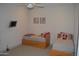 Comfortable bedroom with ceiling fan, mounted TV, and matching twin beds at 11290 N 117Th St, Scottsdale, AZ 85259
